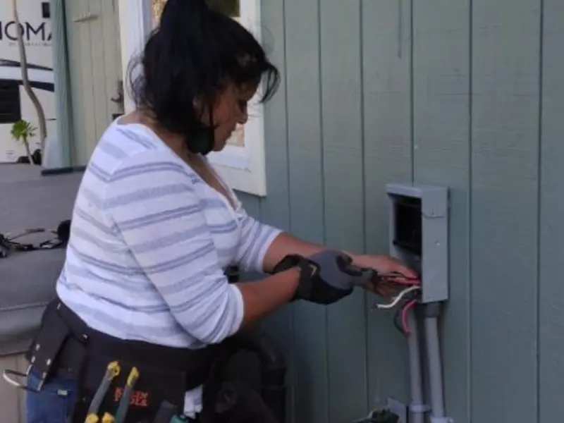 Licensed electrician wiring an exterior subpanel in St. Bernard